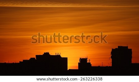 Silhouette of buildings in orange sunset, buildings silhouettes in colourful sunset, evening in the city, dramatic colourful sunset sky in the Vilnius with buildings silhouettes, artistic photo