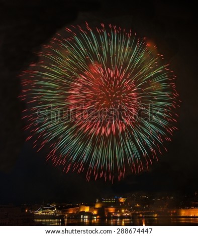 Big colorful fireworks explode in Malta in dark sky,Malta fireworks festival, 4 July, Independence, fireworks explode, New Year, fireworks in Valletta isolated in dark background with place for text