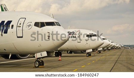 BUCHAREST, ROMANIA - MAY 9: Lots of different airplanes parked on the platform waiting for their passengers at Otopeni Airport on May 9, 2012 in Bucharest, Romania.