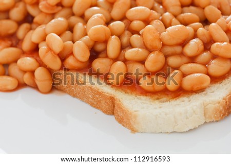 Detail of baked beans on white toast.