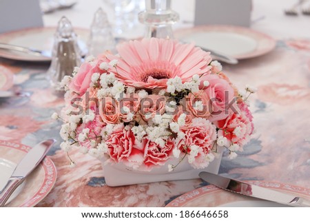 Historical delicate many shades of pink flower arrangement on table