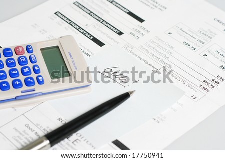 monthly billing statement with pen and calculator