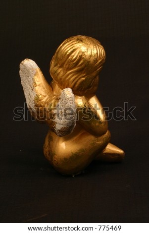 Golden angel figurine, black background