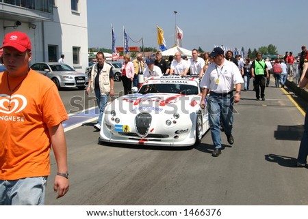 Car and people at the 24h race at the Nuerburgring racetrack, Germany
