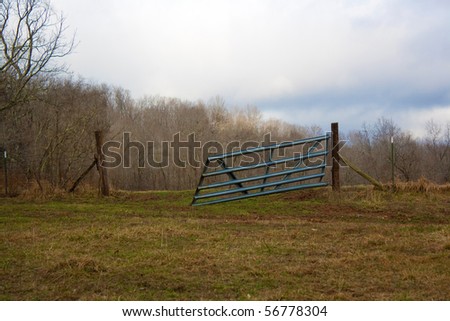 An open metal gate on a farm