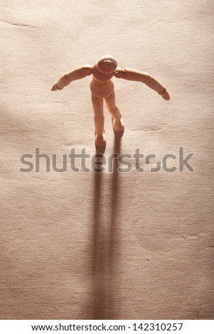 A wooden figure with its shadow.