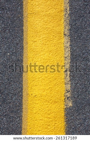 A close up of a yellow stripe on a road.