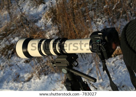 Big telephoto lens on slr photo camera
