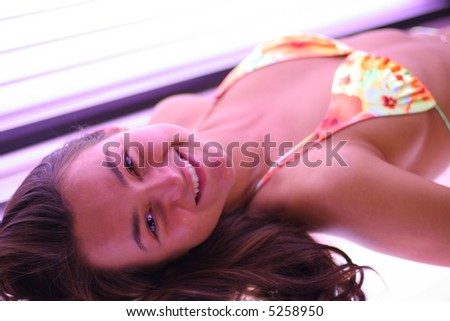 Girl tries to get tanned in solarium. Part of recreation in SPA