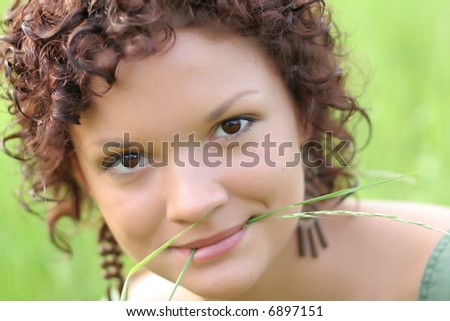 Nice dark haired girl with stem in her lips
