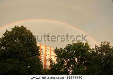 House and bushes during interesting weather - rainbow