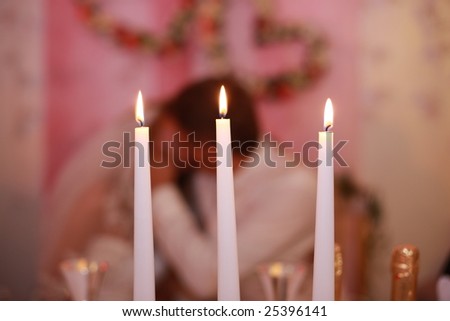 stock photo Three candles on wedding table just married in background