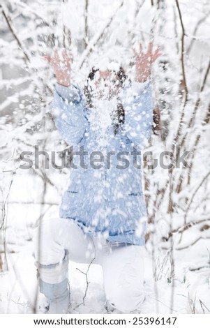 Girl has fun with snow in nice winter day