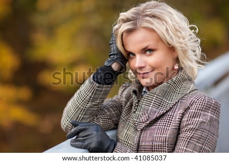 Nice autumn portrait with blond girl in the park