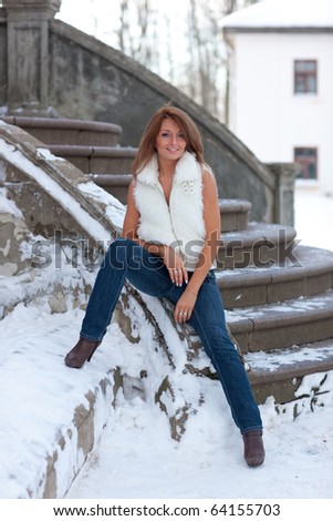 Beautiful girl with fancy clothes sits on stair