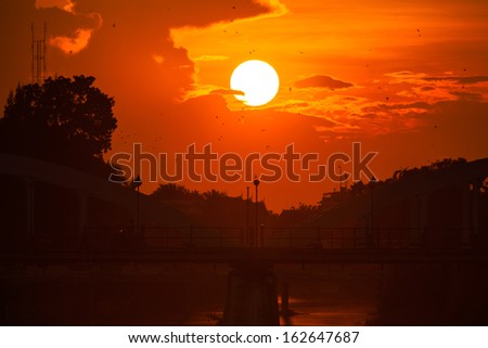 Bridge with a beautiful cloudy sunset in the background.Lampang,Thailand