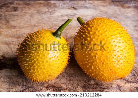 Gac,Baby Jackfruit Spiny Bitter Gourd, Sweet Gourd.A Southeast Asian fruit isolate on wood.