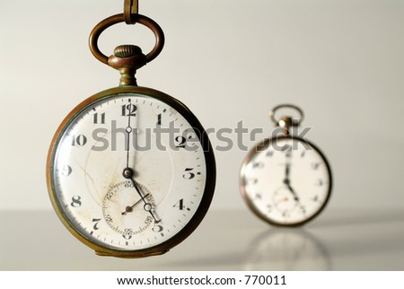 perspective of two old clocks at five o\'clock
