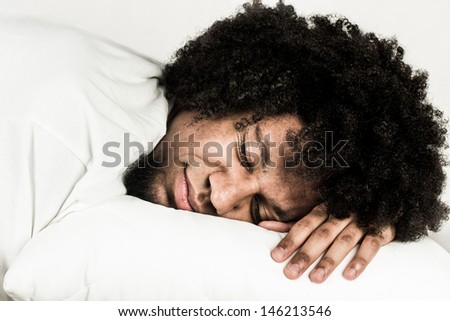 Young man sleeping on white pillow