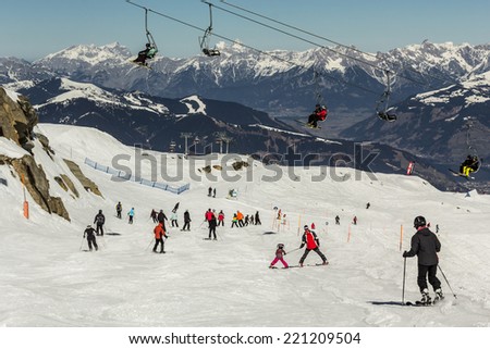 Skiing people and the chair lifts of ski region in Austria