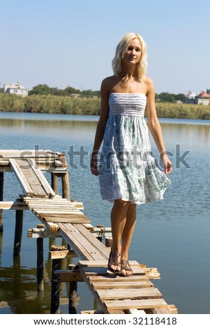 Girl walking along the pier on a hot sunny day