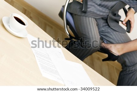 Young businessman and businesswoman flirting in office