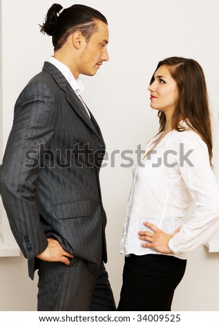 Young businessman and woman having an argument in office