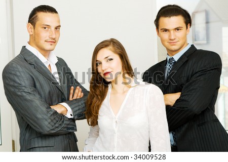 Successful business team of two men and one woman