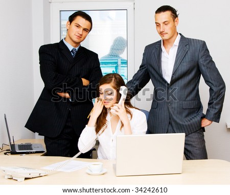 Successful business team of two men and one woman