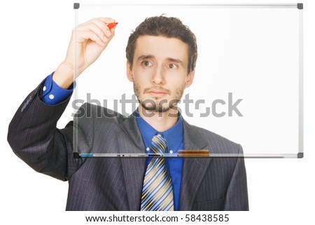Young businessman writing something with a marker on blackboard, white background