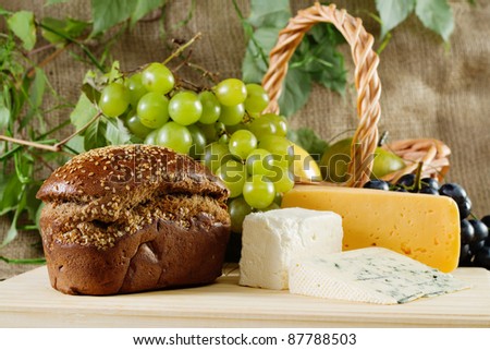 Bread, cheese and grapes still-life