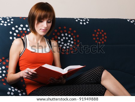 Young beautiful girl resting at home on the sofa