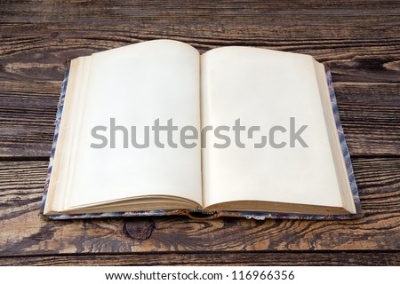 Aged blank book on wooden table, blank pages