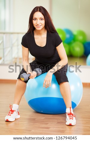 Woman in a gym on a ball