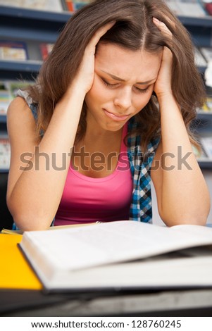 Stressed female student in a university library
