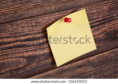 Yellow note on a wooden board