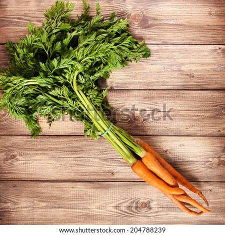 Raw carrot on a wooden table