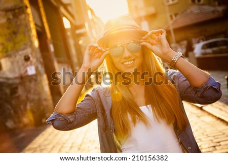 Young stylish woman walking in a city street