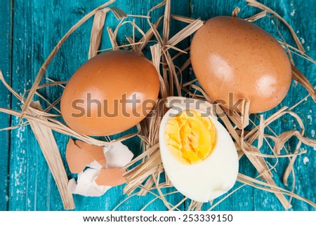 Organic eggs on blue wood background.