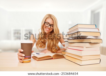 Young student reading books at the table