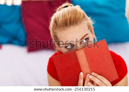 Pretty blond woman reading a book