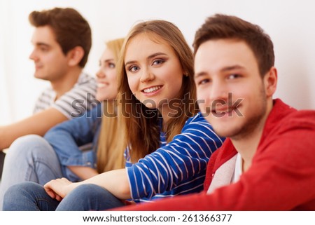 Group of four young people indoors, selective focus