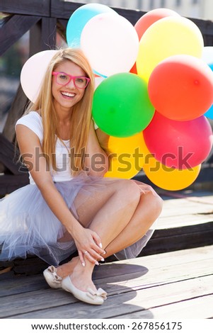Young beautiful woman with air balloons.