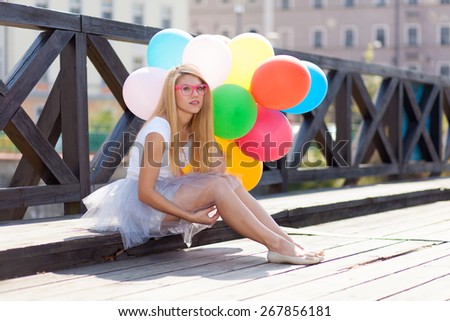 Young beautiful woman with air balloons.