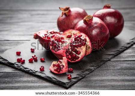 Red juice pomegranate on dark background