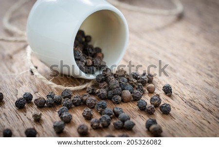 black pepper spill on wooden