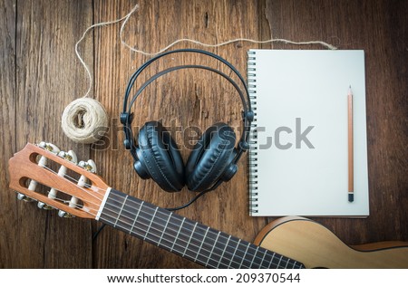 headphone guitar notebook and pencil