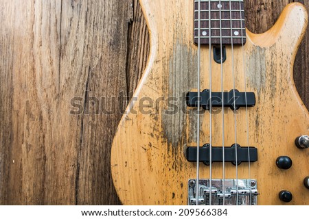 old bass guitar on wooden background