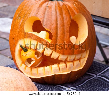 Cuted Halloween pumpkin eating small pumpkin