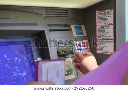 GREECE, Crete, Heraklion - JUNE 30, 2015: Woman uses cash machine outside the closed bank in the capital of Crete. Greek banks will stay closed for six days.